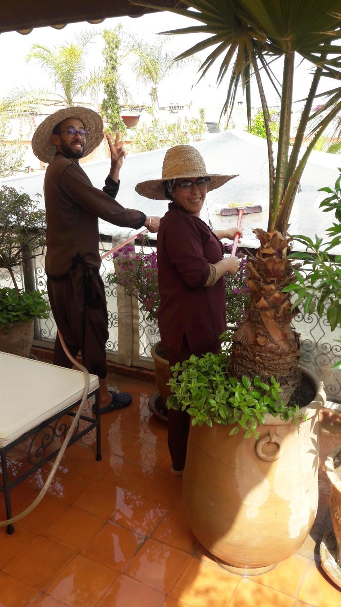 Riad Les Nuits De Marrakech Marrakesh Exterior photo A woman watering a plant